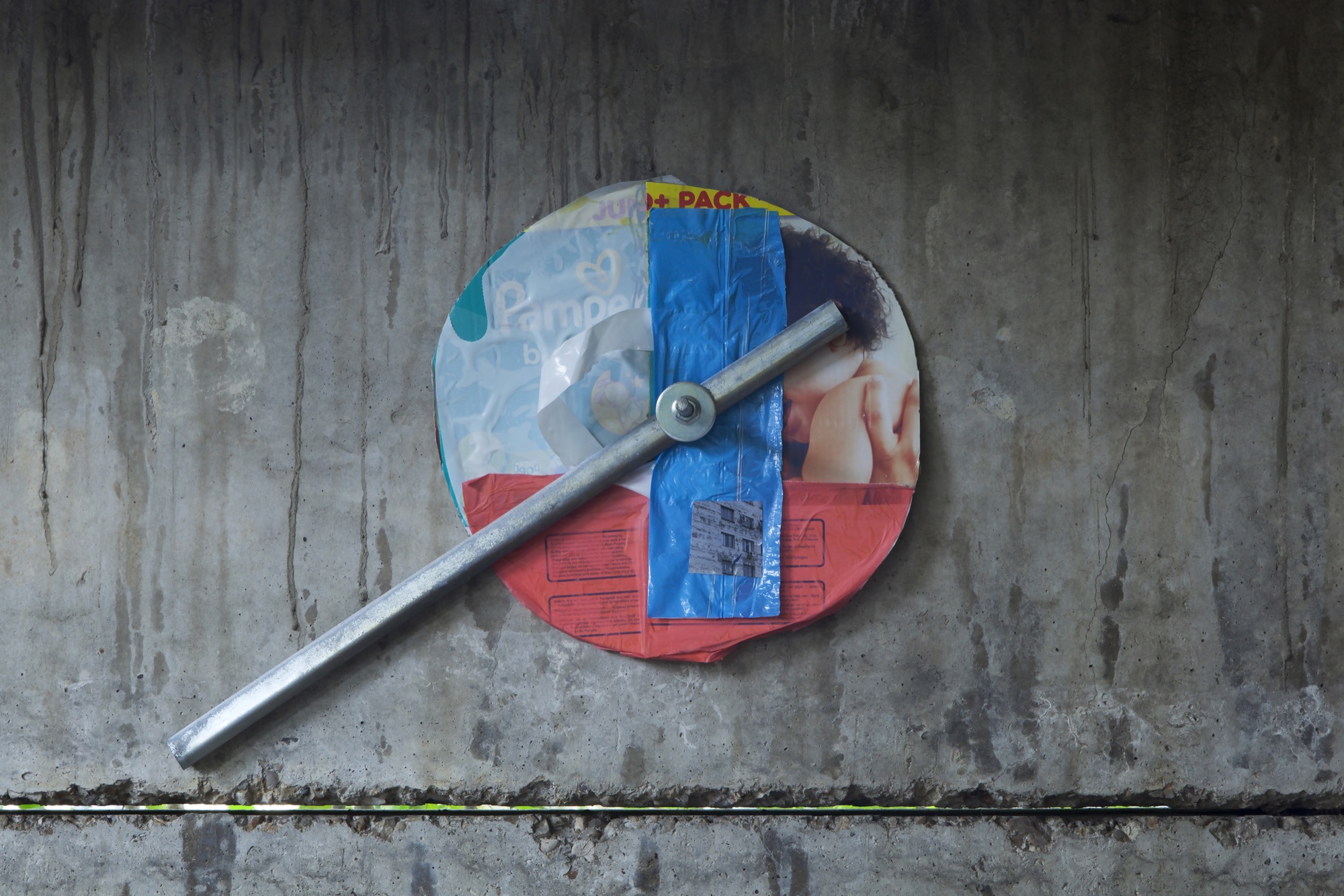 + Pack | 2015 | photograph, plastic bags, cardboard, metal, concrete bolt | 40 x 50 cm | https://phelimmcconigly.net/?page_id=39